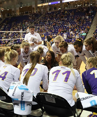 Head Coach Bobbi Peterson and the coaching staff during a match